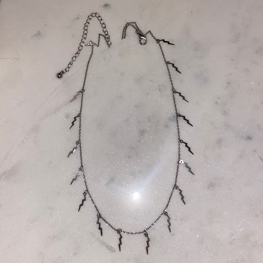 Silver, lightening bolt necklace, worn once, super cute! Not sure of the brand.